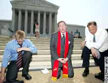 Left to right: Michael Summers of Bend, Oregon, Rev. Rob Schenck, and pastor Ken Wilde pray outside the Supreme Court in Washington Thursday.